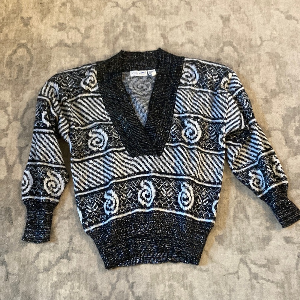 Cristina’s black and white with silver pattern sweater